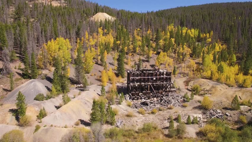 4k Aerial/drone footage of the bright yellow aspen leaves & an abandoned mine building in the Colorado Rocky Mountains.  Filmed near Breckenridge Colorado, USA