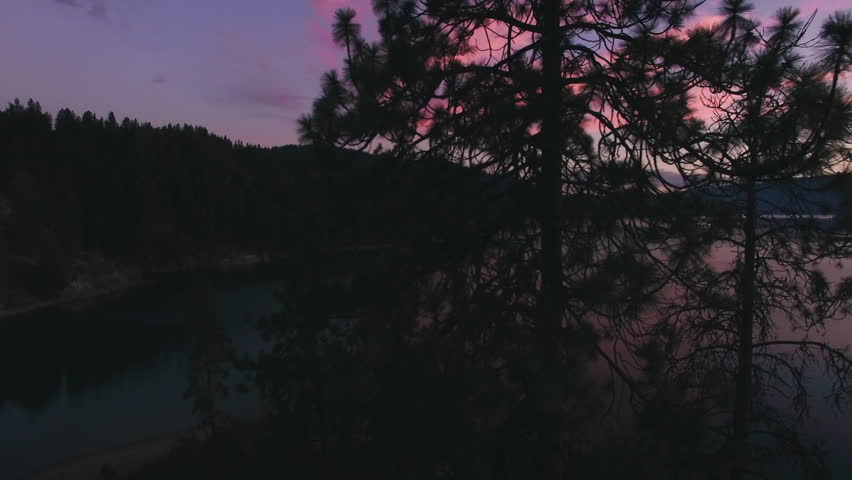 Aerial Dolly Shot to Reveal Pink Clouds Over Big Lake at Dusk