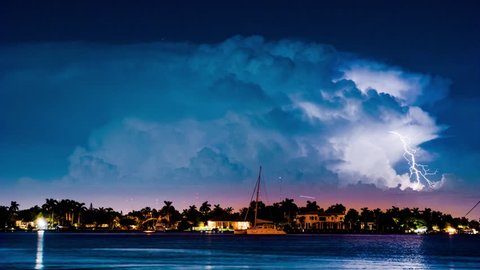 Thunderstorm clouds with lightning bolts flashing over Hollywood cityscape in Miami, Florida. 4K UHD Timelapse.