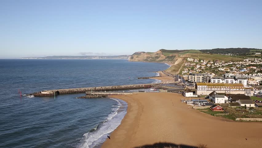 West Bay Dorset England uk view to west over small town on Jurassic coast south of Bridport on a beautiful day with blue sky and sea