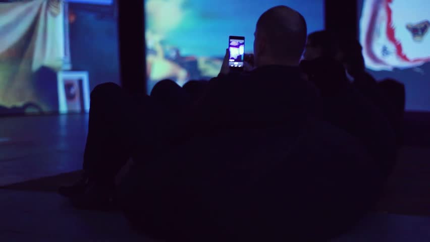 Russia, Novosibirsk, 13 november 2015. Art Exhibition by Dali. Undefinded man takes picture from his smartphone. 1920x1080