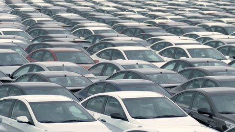 a large number of cars in the Parking lot. Storage area for new unsold cars at the plant स्टॉक वीडियो