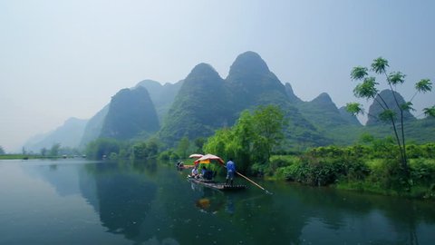Bamboo raft flowing through the idyllic rural landscape of Yangshuo
