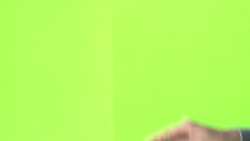 Woman slating a take with clapper board on green screen, close up