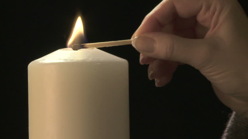 Lighting a candle close up