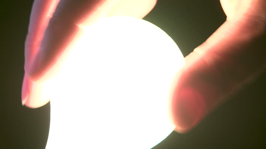 Male Hand and Light Bulb close up