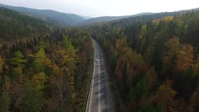 Video drone aerial view over the road in the forest on the way to Lake Baikal