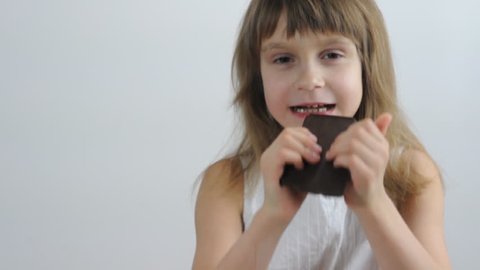 portrait of a little girl eating chocolate