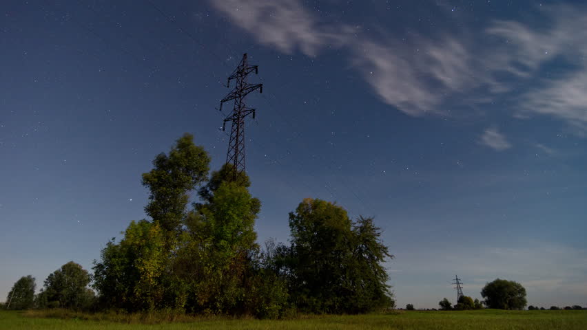 Time lapse of a electricity pylon in front of Startrails