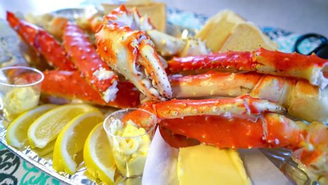 Red king crab legs with fresh lemon slices. Delicious seafood and luxury restaurant menu.
