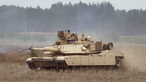 GAIZIUNAI, LITHUANIA - JUNE 18, 2015: Tank drives on the battlefield. Close-up of M1A2 Abrams during NATO exercise Saber Strike 2015.
