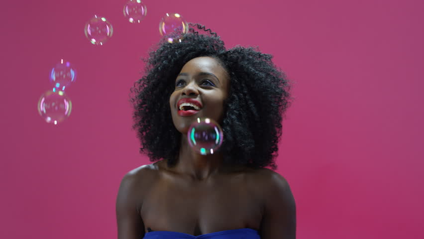 attractive black woman playing bubbles on: стоковое видео (без лицензионных...
