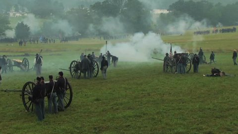 GETTYSBURG, PENNSYLVANIA - JULY 2008 - large-scale, epic Civil War anniversary reenactment -- in the middle of battle. Union and Confederate Artillery firing and fighting, cannons with smoke, explodes