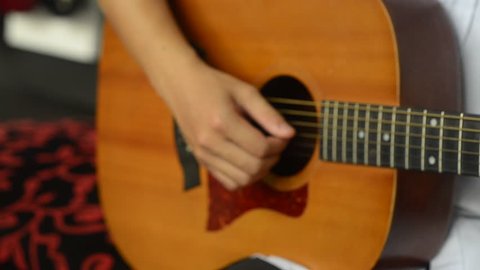 Acoustic guitar in musician hands