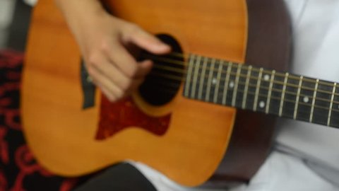 Acoustic guitar in musician hands