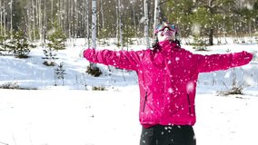 A woman enjoys snow during the winter, Young Woman Enjoys in the Winter on a Mountain in Slow Motion, Slow Motion Video clip