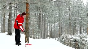 Cleaning snow with red shovel in slow motion in close up, Cleaning Snow with a Shovel on a Mountain in Slow Motion, Slow Motion Video Clip