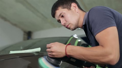 A man polishes the car body
