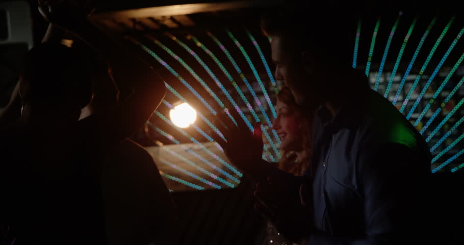 Group of friends dancing in pub at bar 4k