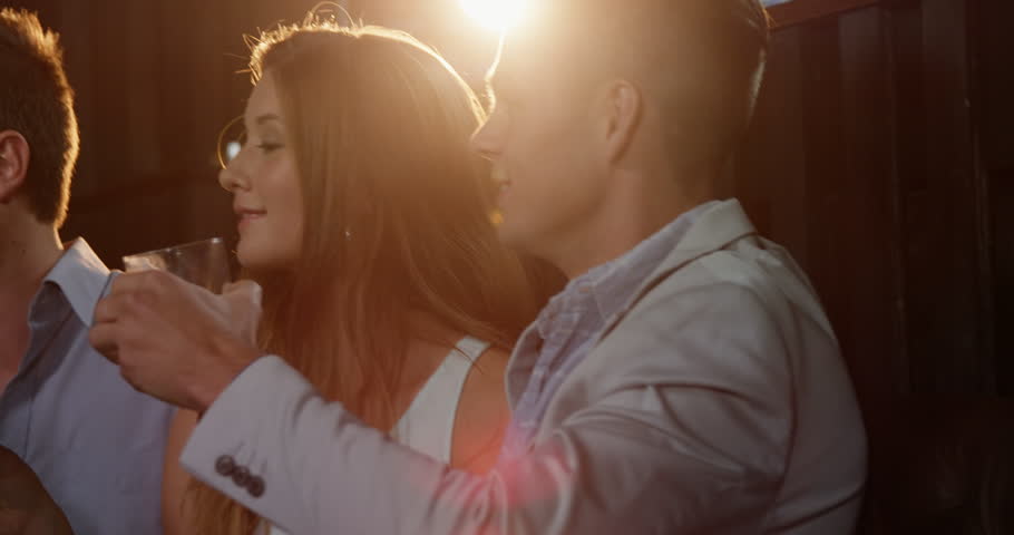 Group of friends toasting cocktail in bar 4k