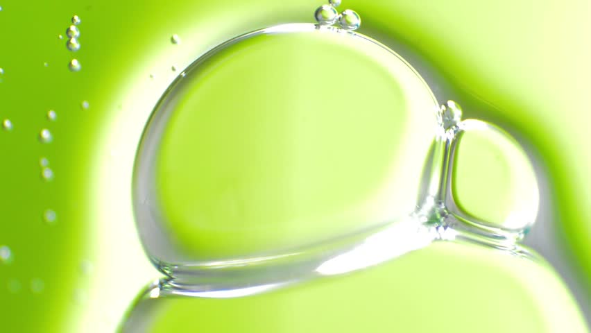 Soap bubbles on a green background, macro view.
