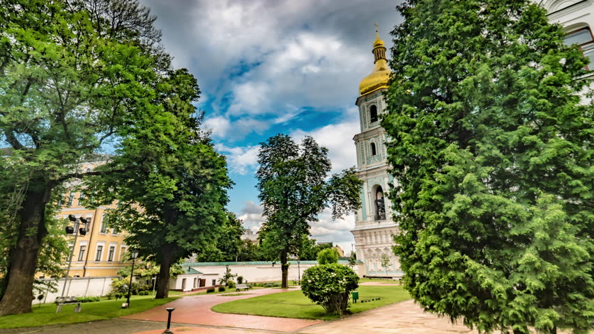 Kiev. on the Territory of the National Reserve "sophia of Kyiv". High Bell Tower of St. Sophia Cathedral With a Gold Dome. the Ancient Monastic Buildings. Tourists in the Monastery of the Tracks.