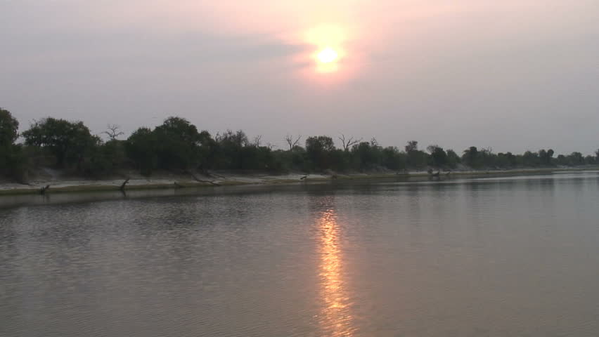 The sun sets on the Chobe River in Botswana, Africa. 