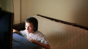 Teen boy plays games on the computer at night. Online Games