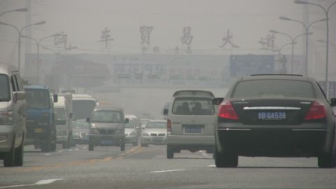 QINGDAO - APRIL 29: Traffic drives through thick smog at a road on April 29, 2010 in Qingdao, China.