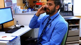 Doctor talking on mobile phone at the hospital 4k - Powered by Shutterstock - Get 15% off with code: PIKWIZARD15