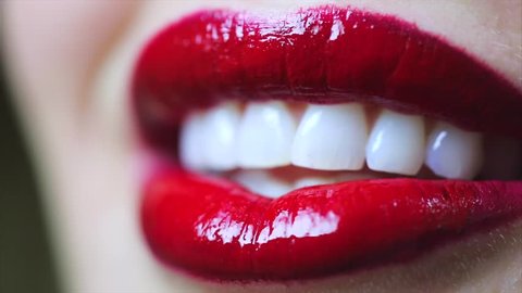 Extreme close up of lips blowing a kiss and smiling