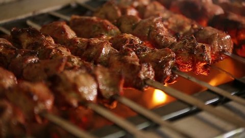 Cook roasts juicy kebab barbecue with crispy grilled slowmotion