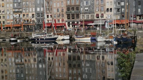 HONFLEUR, FRANCE - SEPTEMBER 2016: Colorful facades water reflection of famous northern Normandy artistic place and port by the day slow tilting footage