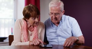 4k Senior retired couple struggling with their finances. Calculating their savings. - Powered by Shutterstock - Get 15% off with code: PIKWIZARD15