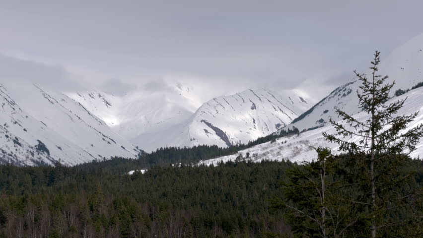 Rolling Clouds Over Alaska Mountains and Snow
