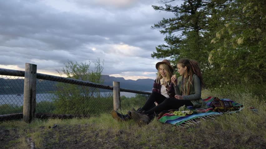 Friends Enjoy A Picnic In The Columbia River Gorge, They Eat And Talk About The View