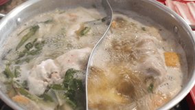 Delicious shabu with egg served in a hot pot style, stock video