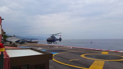 Fontvieille, Monaco - October 01, 2016: Helicopter Landing on the Platform Above the sea in the Monte Carlo International Heliport (Monaco Heliport) in Monaco, French Riviera
