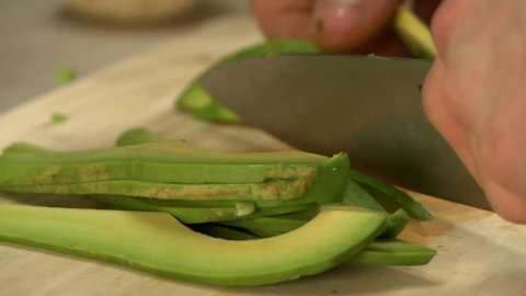 View of chef slicing avocado, close-up