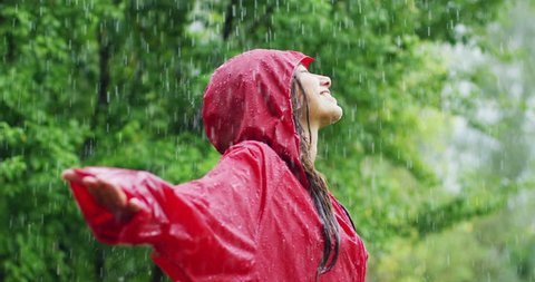  happiness and rain. A happy woman smiles in the rain, the woman immersed in the nature of dance under the rain in slow motion. Concept of love, nature, happiness, freedom. Stock Video