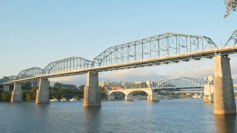 A view of the Walnut Street pedestrian bridge and traffic crossing the Market Street and Olgiati bridges over the Tennessee River shortly after sunrise in Chattanooga, Tennessee.