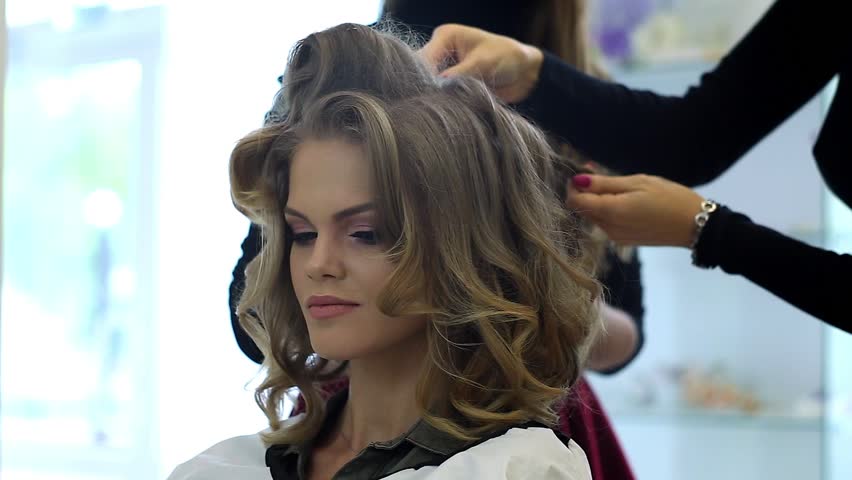 Hairdresser makes hairdress beautiful girl in a beauty salon Royalty-Free Stock Footage #20075065