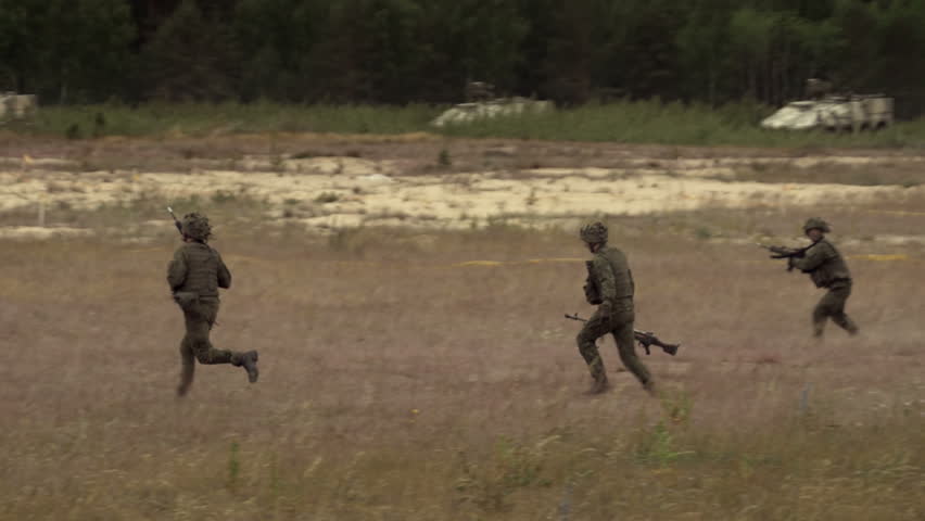 GAIZIUNAI, LITHUANIA - JUNE 18, 2015: Soldiers run with weapons. Slow motion of soldiers in uniforms shooting in the field during NATO exercise Saber Strike 2015. | Shutterstock HD Video #20077045