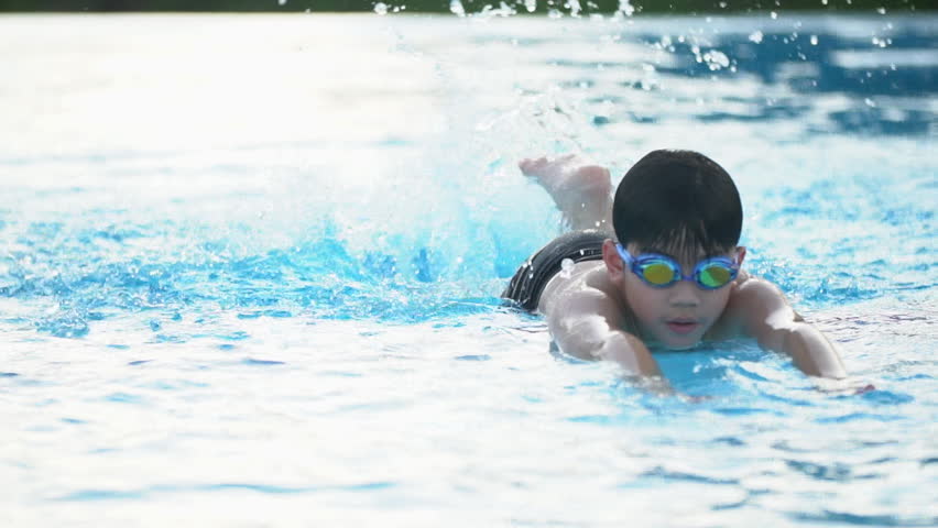 Slow motion of asian child playing in pool, Happy boy having fun on vacation.