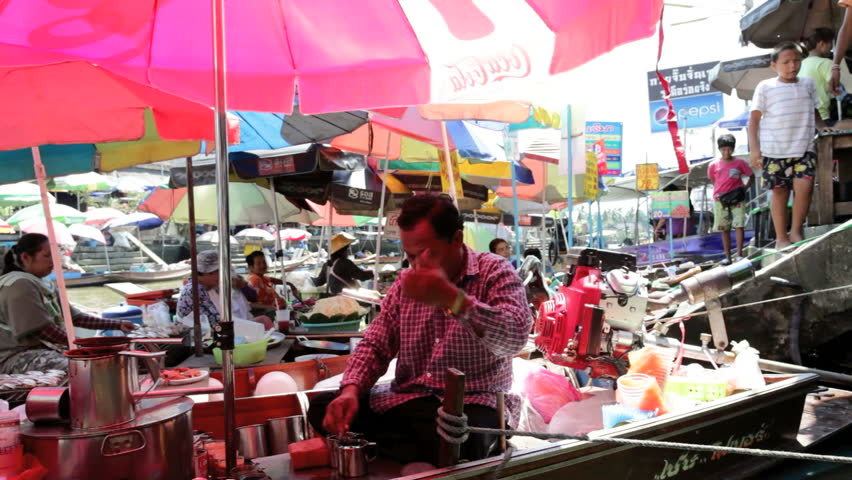 AMPHAWA, THAILAND - FEBRUARY 25: A vendor is selling coffee on the Amphawa