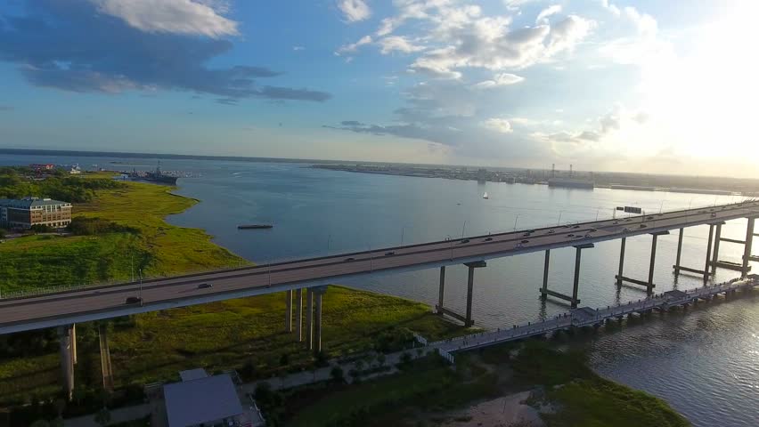 4k Cinematic Epic Aerial of Cargo Ships in Charleston SC Harbor. Done flying over Arthur Ravenel Jr. Bridge at sunset. Global ship trade in South Carolina. 