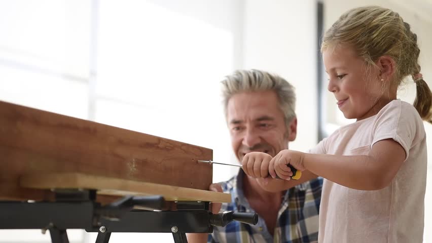 Little girl helping daddy with do-it-yourself work