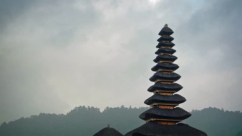 Rain clouds slowly drift over the exotic. tiered pagodas of Pura ulun Danu Bratan. a Hindu temple in Bali. Indonesia.