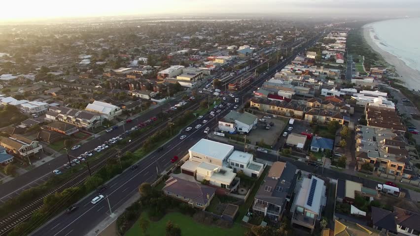 Horizontal pan across Patterson Lakes suburb, river, and Nepean Highway bridge at sunrise. Melbourne, Victoria, Australia.