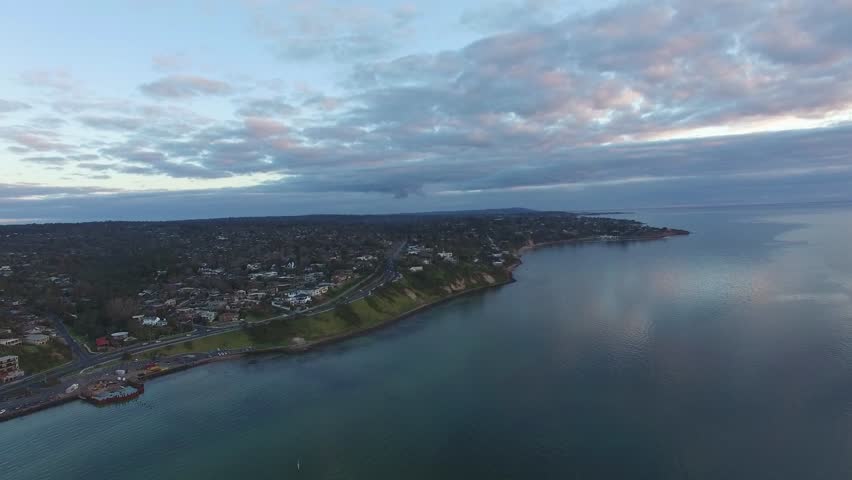 Smooth horizontal pan across Olivers Hill in Frankston and Nepean Highway from high above the ground level. Melbourne, Victoria, Australia